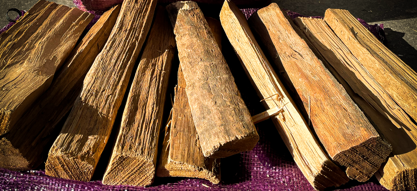 Stack of kiln dried firewood on a purple fabric background