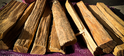 Stack of kiln dried firewood on a purple fabric background
